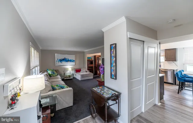 a living room with furniture a dining table and a fireplace