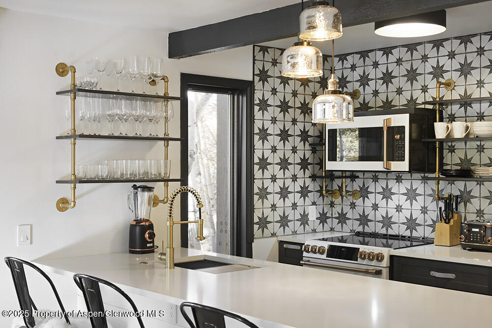 a kitchen with stainless steel appliances kitchen island granite countertop a refrigerator and a stove top oven