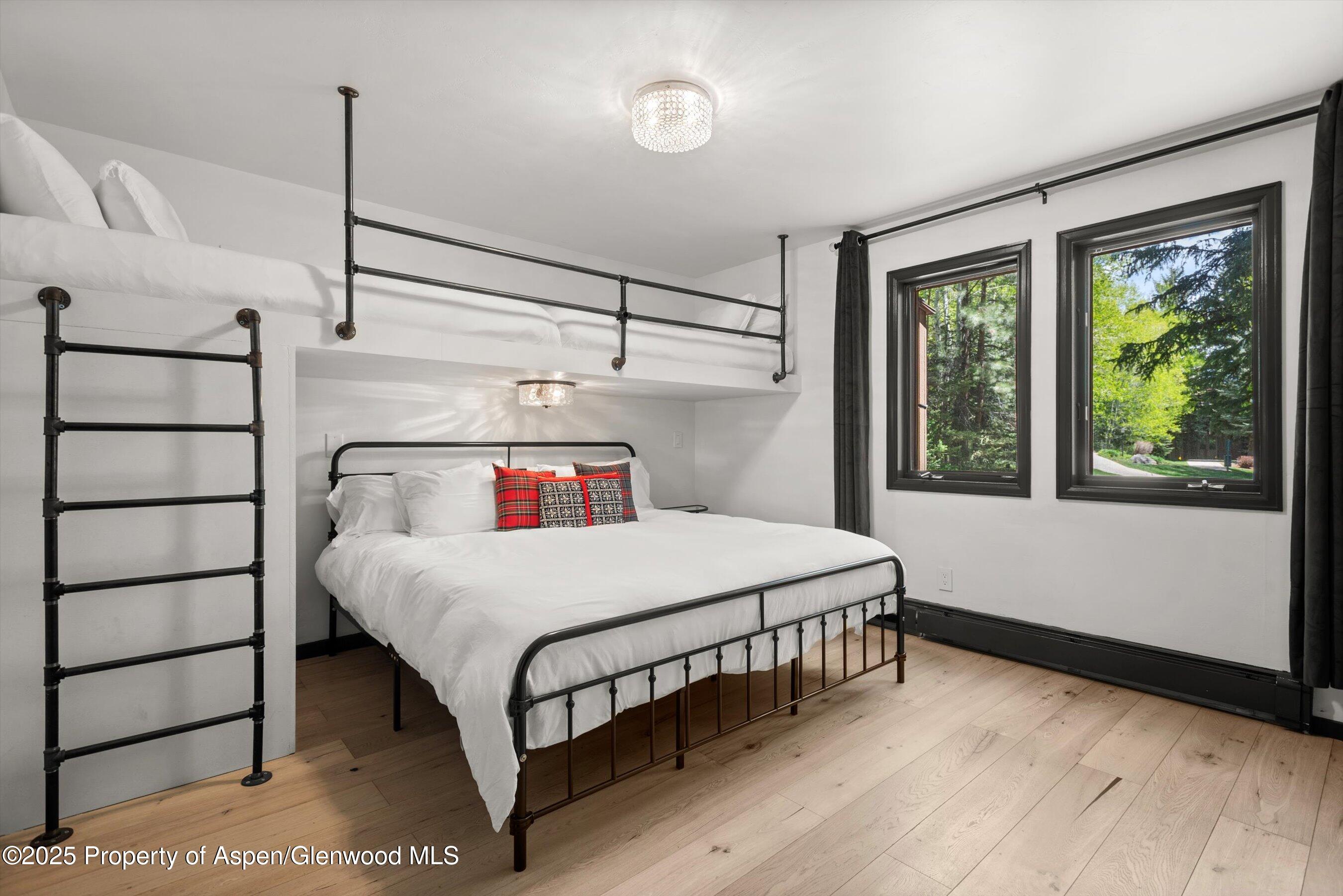 35 Upper Woodbridge Road, Unit 2A Snowmass Village, CO 81615 - Photo 12 of 29 a bedroom with a bed and large window