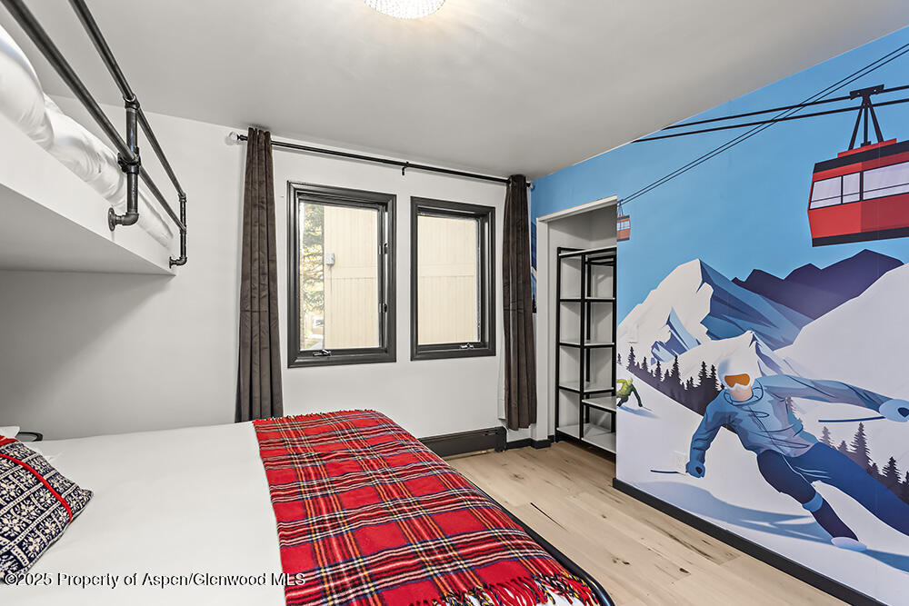 35 Upper Woodbridge Road, Unit 2A Snowmass Village, CO 81615 - Photo 13 of 29 a bedroom with a bed and a dresser