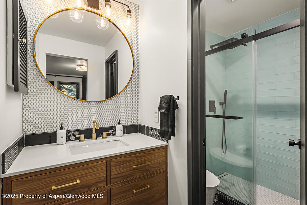 35 Upper Woodbridge Road, Unit 2A Snowmass Village, CO 81615 - Photo 14 of 29 a bathroom with a sink vanity and a mirror