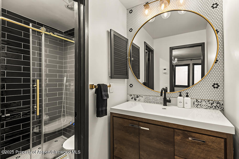 35 Upper Woodbridge Road, Unit 2A Snowmass Village, CO 81615 - Photo 18 of 29 a bathroom with a sink mirror and vanity