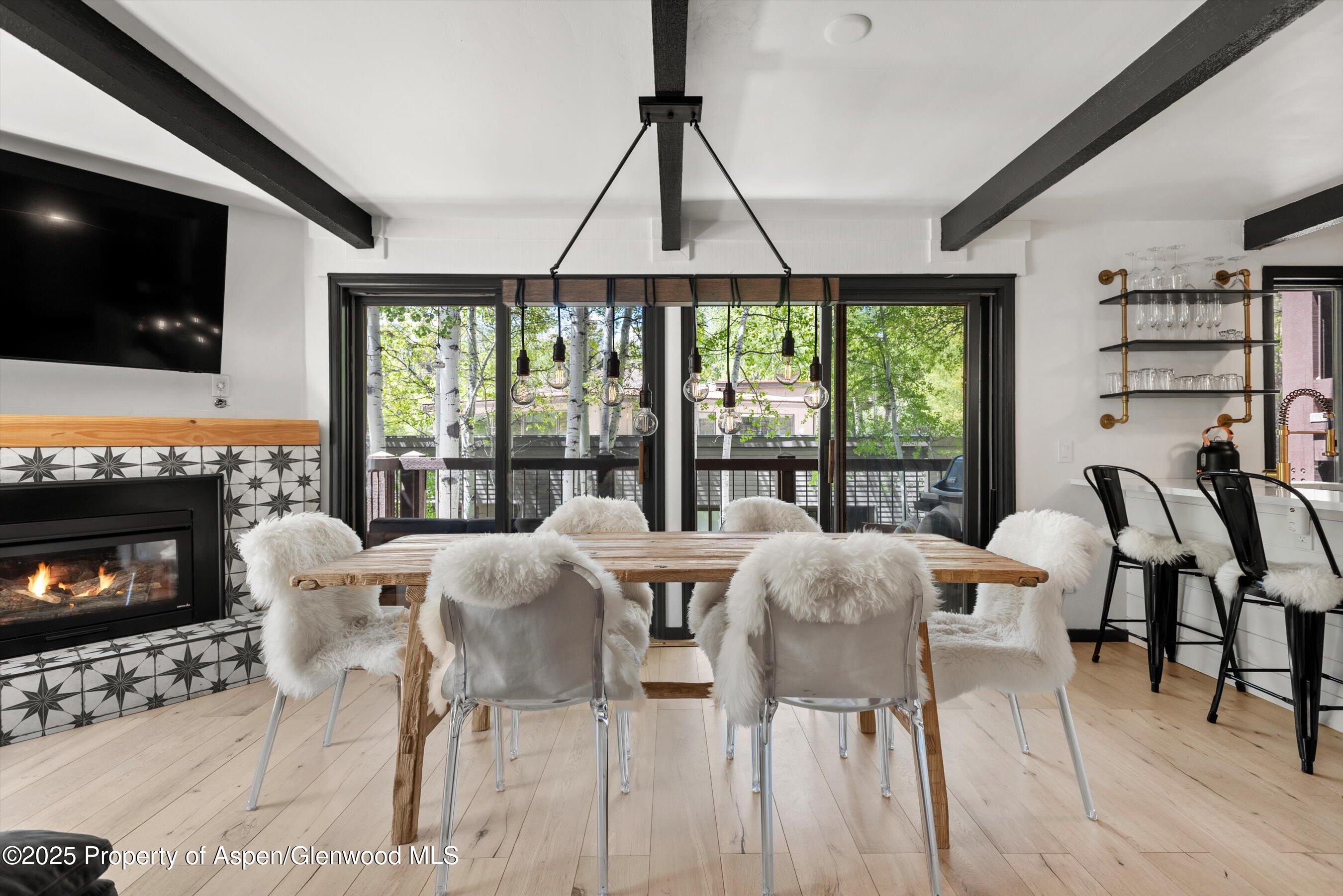 35 Upper Woodbridge Road, Unit 2A Snowmass Village, CO 81615 - Photo 2 of 29 a view of a livingroom with furniture and a flat screen tv