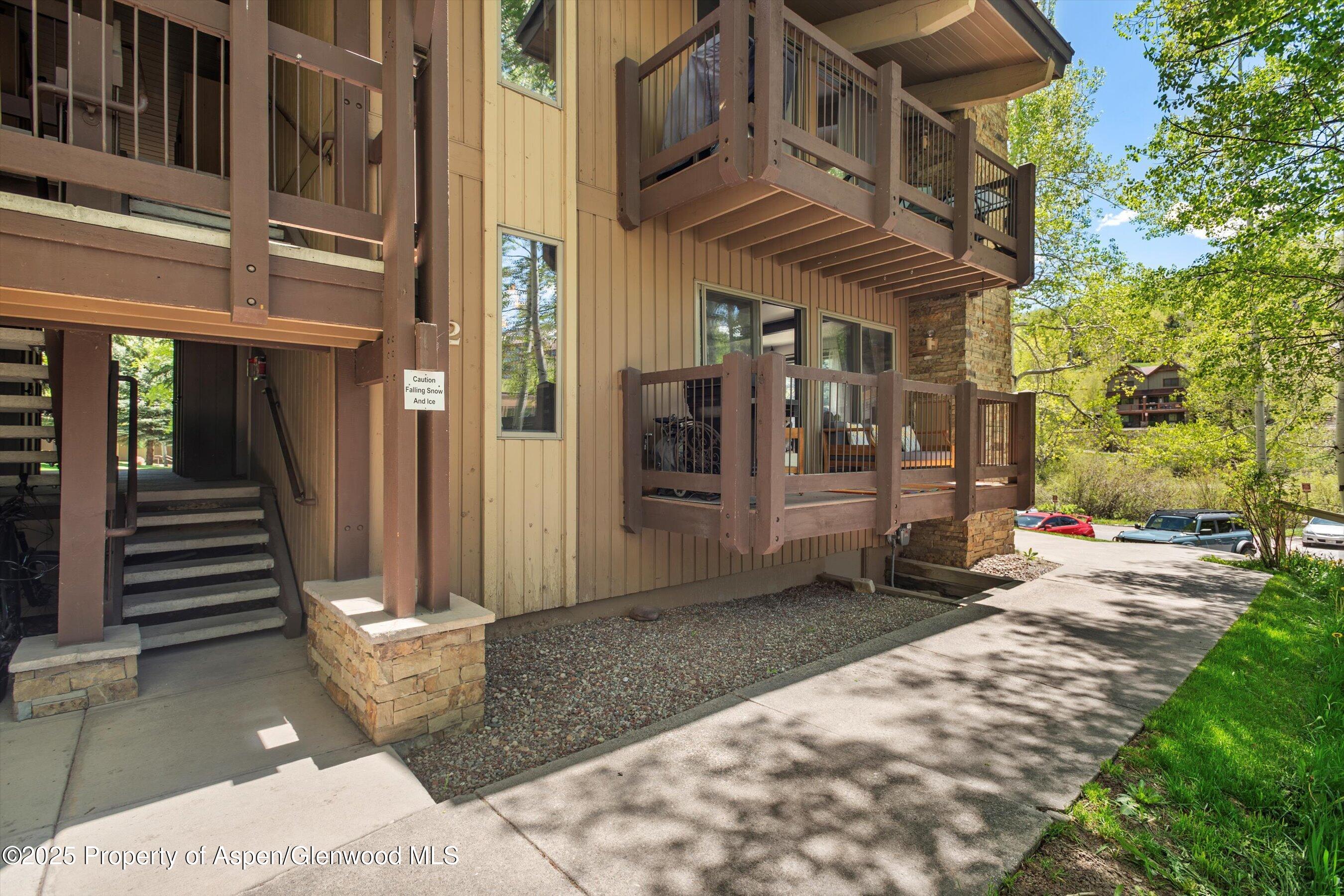 35 Upper Woodbridge Road, Unit 2A Snowmass Village, CO 81615 - Photo 26 of 29 a view of a building with door and outdoor seating