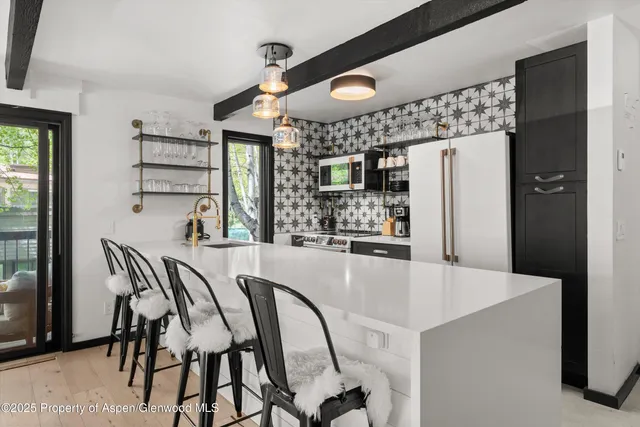 a dining table chair next to a window