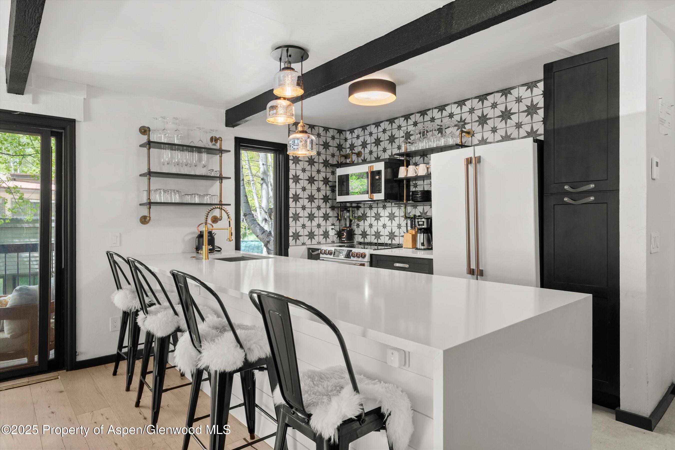 35 Upper Woodbridge Road, Unit 2A Snowmass Village, CO 81615 - Photo 3 of 29 a dining table chair next to a window