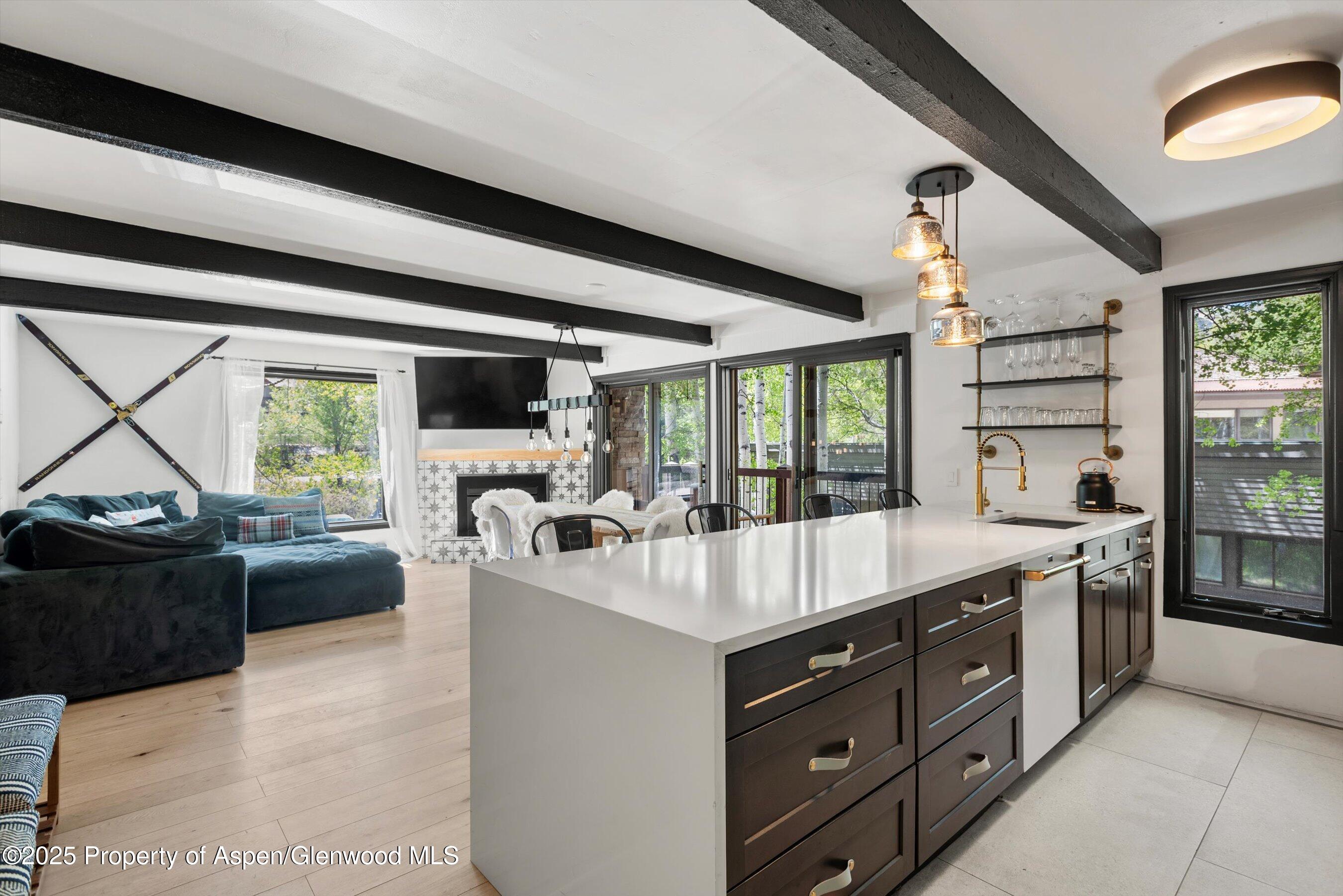 35 Upper Woodbridge Road, Unit 2A Snowmass Village, CO 81615 - Photo 6 of 29 a large white kitchen with a large window