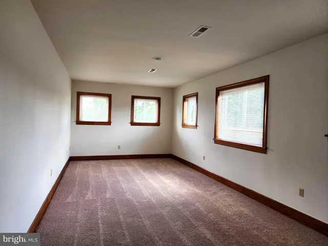 a view of an empty room with windows