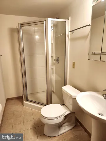 a white toilet sitting next to a bathroom sink