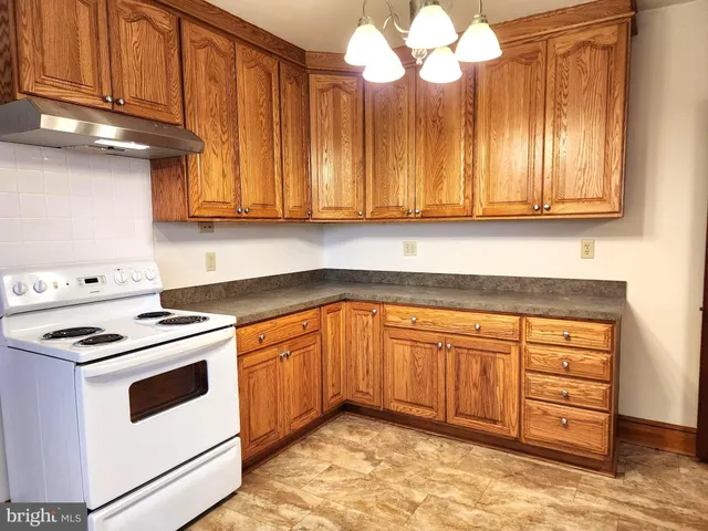 a kitchen with a sink cabinets and window
