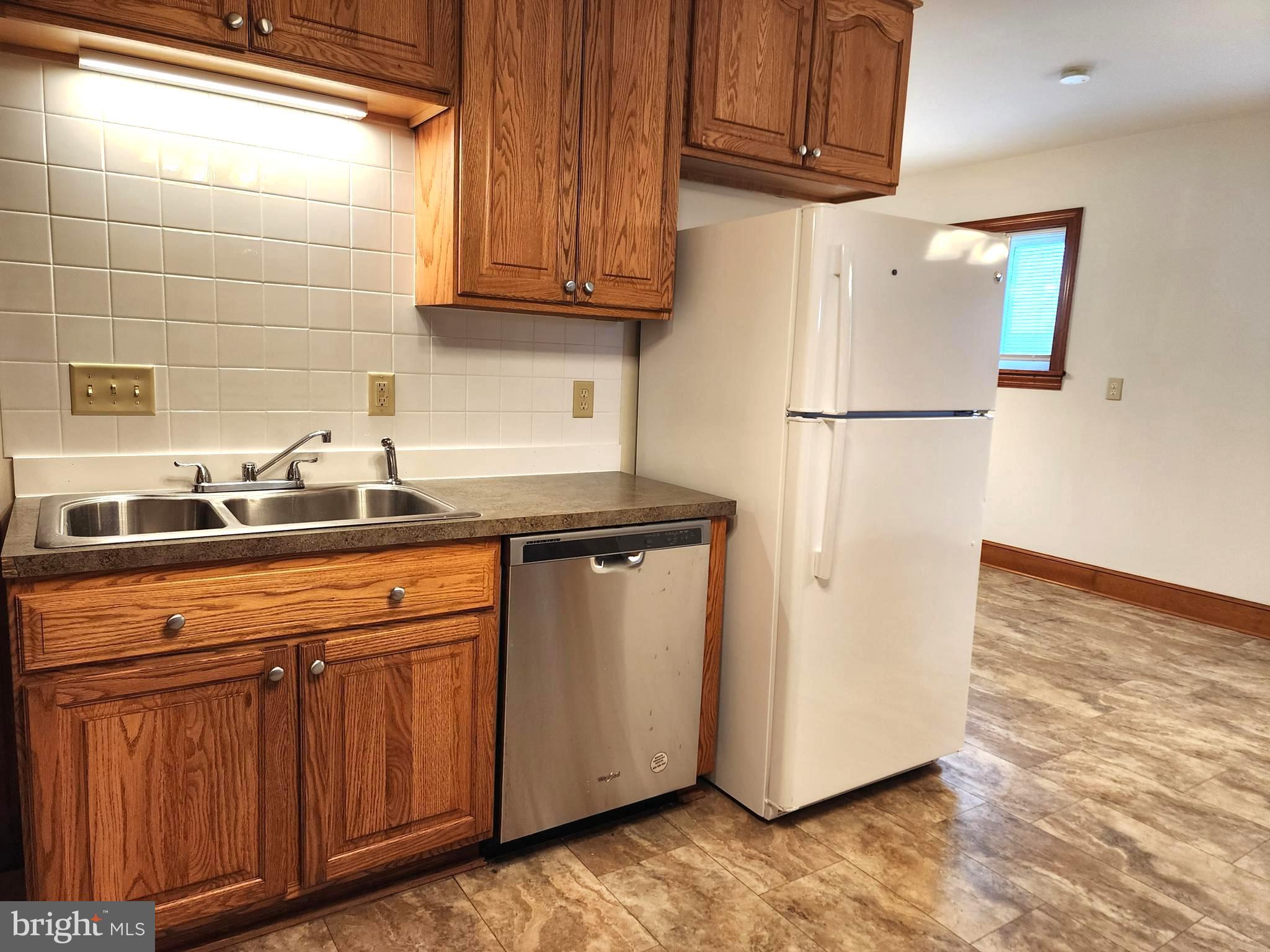 14352 Ridge Road King George, VA 22485 - Photo 8 of 30 a kitchen with stainless steel appliances granite countertop a refrigerator and a sink
