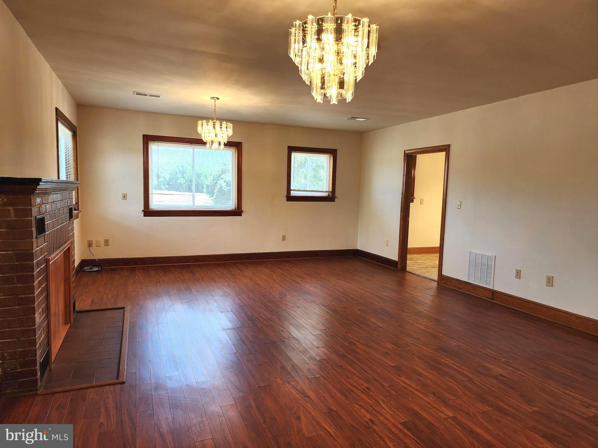 14352 Ridge Road King George, VA 22485 - Photo 10 of 30 a view of an empty room with wooden floor and a chandelier