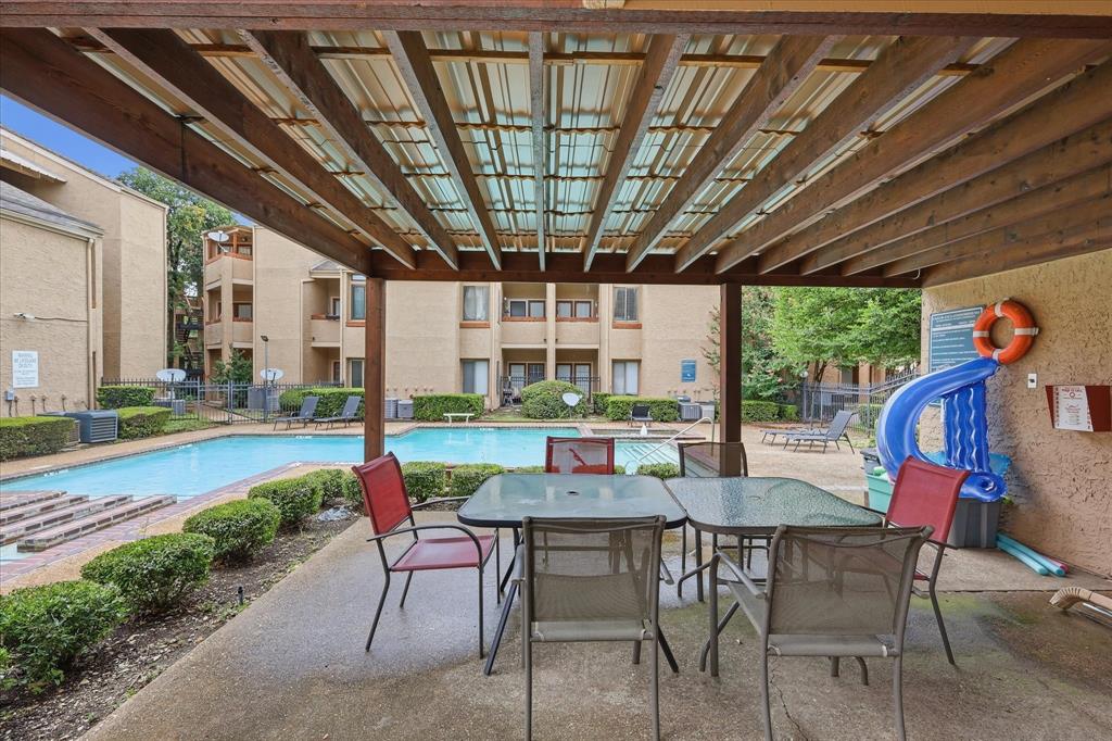 5550 Spring Valley Road, Unit A31 Dallas, TX 75254 - Photo 21 of 24 Covered patio area featuring a slatted wooden pergola and concrete flooring