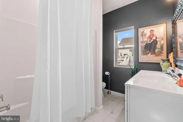 a en suite bathroom with a sink a toilet and a shower