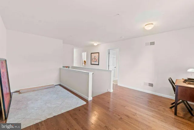 a view of a livingroom with wooden furniture and a window