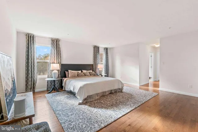 a bedroom with a large bed and a dresser