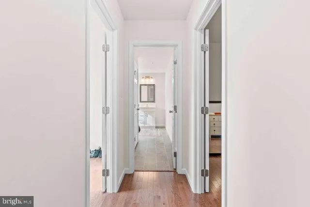 a view of a hallway with wooden floor