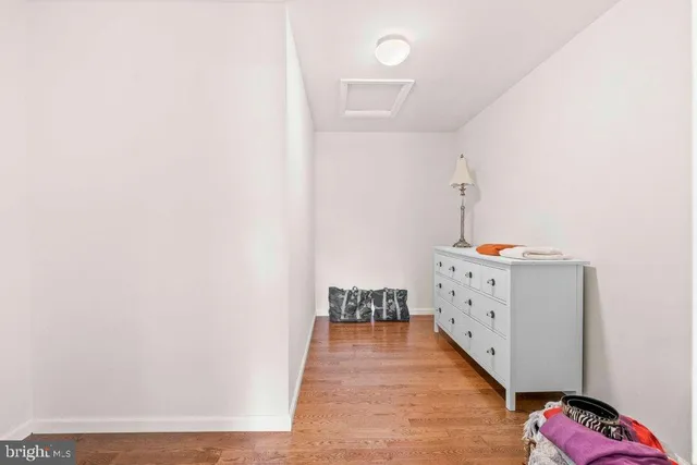 a view of hallway with wooden floor