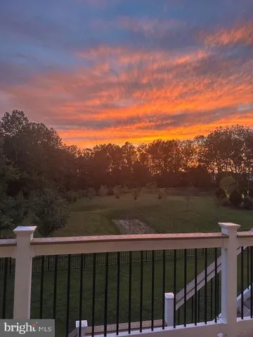 a view of a balcony with wooden floor and fence