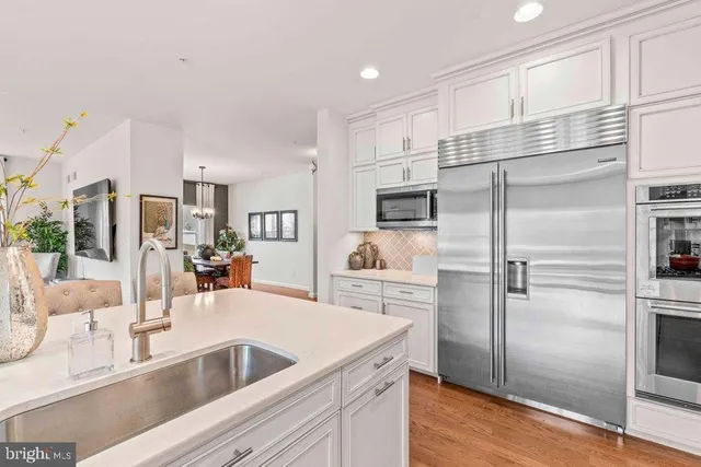 a kitchen with a refrigerator sink and cabinets