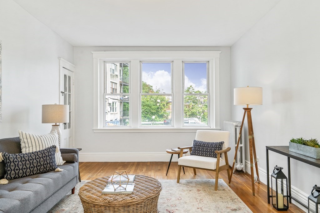 8 Kinross Road, Unit 4 Boston, MA 02135 - Photo 2 of 13 a living room with furniture and a large window