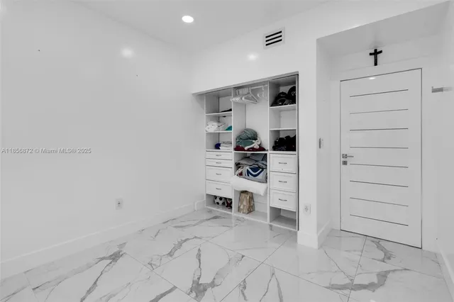 a kitchen with stainless steel appliances kitchen island granite countertop a table and chairs in it
