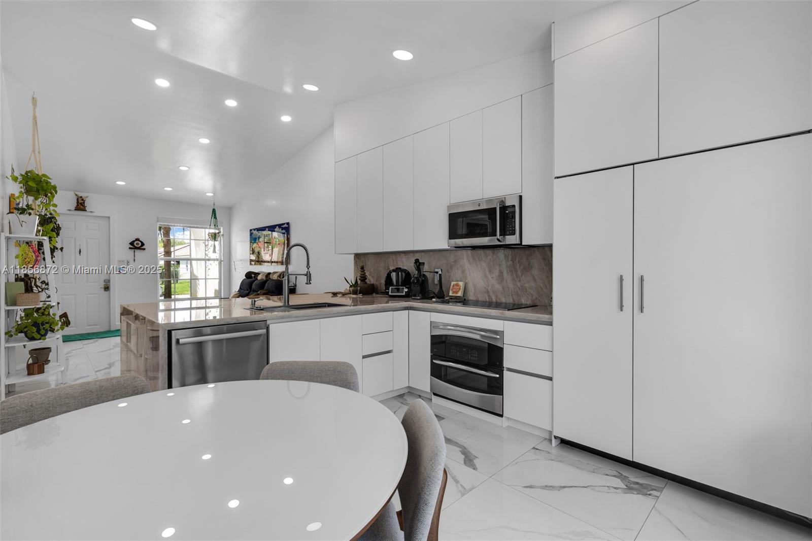 18801 Southwest 25th Court Miramar, FL 33029 - Photo 33 of 41 a kitchen with a sink cabinets and stainless steel appliances