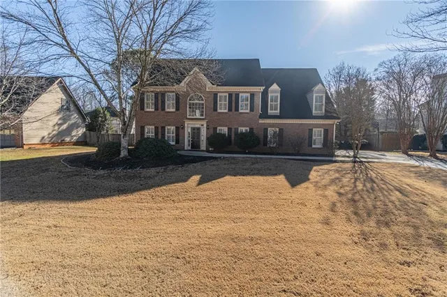 a view of house with snow on the road