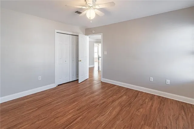a view of an empty room with wooden floor