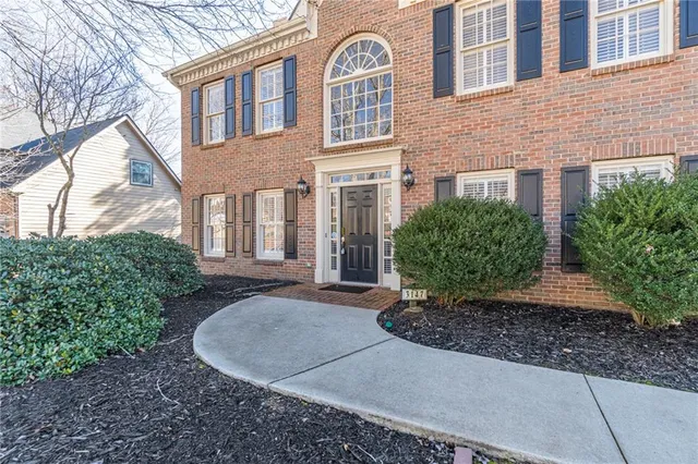 a view of a brick building next to a yard