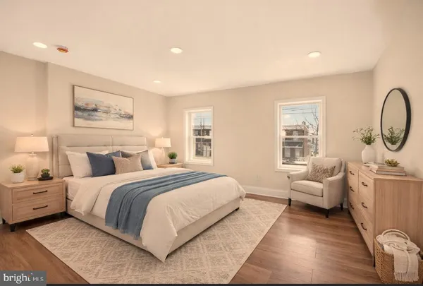a spacious bedroom with a bed and glass windows
