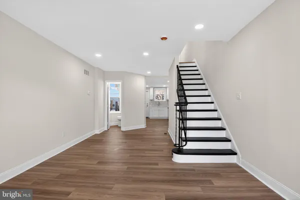 a view of entryway and hall with wooden floor