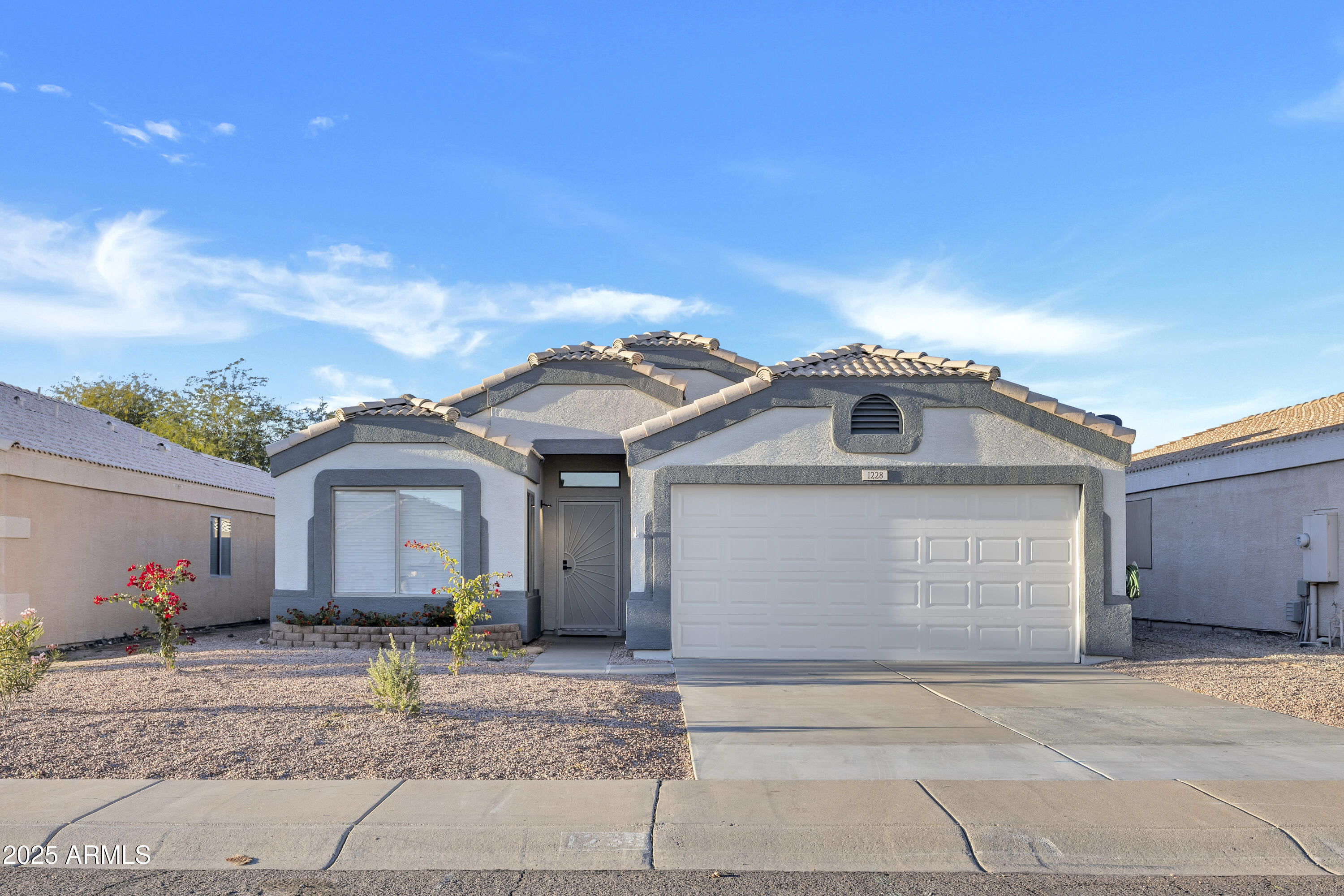 1228 West Diamond Avenue Apache Junction, AZ 85120 - Photo 1 of 25 a front view of a house with a yard and garage