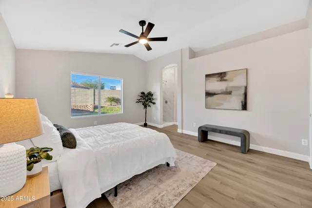 a bedroom with a bed a couch and a window