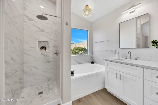 a bathroom with a bathtub a sink and a shower