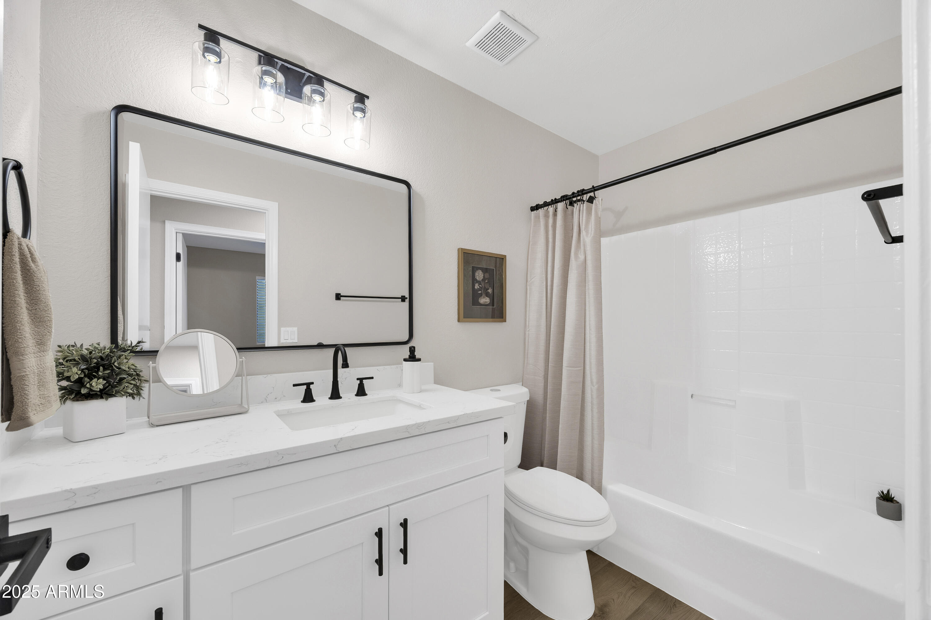 1228 West Diamond Avenue Apache Junction, AZ 85120 - Photo 18 of 25 a bathroom with a sink a toilet a mirror a vanity and shower