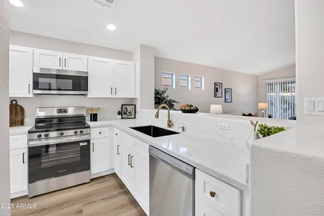 a kitchen with stainless steel appliances a stove microwave and cabinets