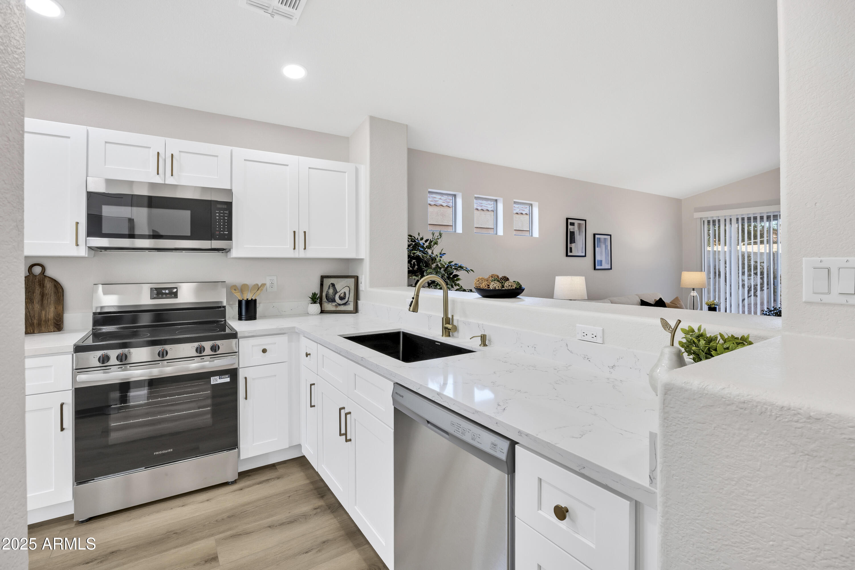 1228 West Diamond Avenue Apache Junction, AZ 85120 - Photo 8 of 25 a kitchen with stainless steel appliances a stove microwave and cabinets