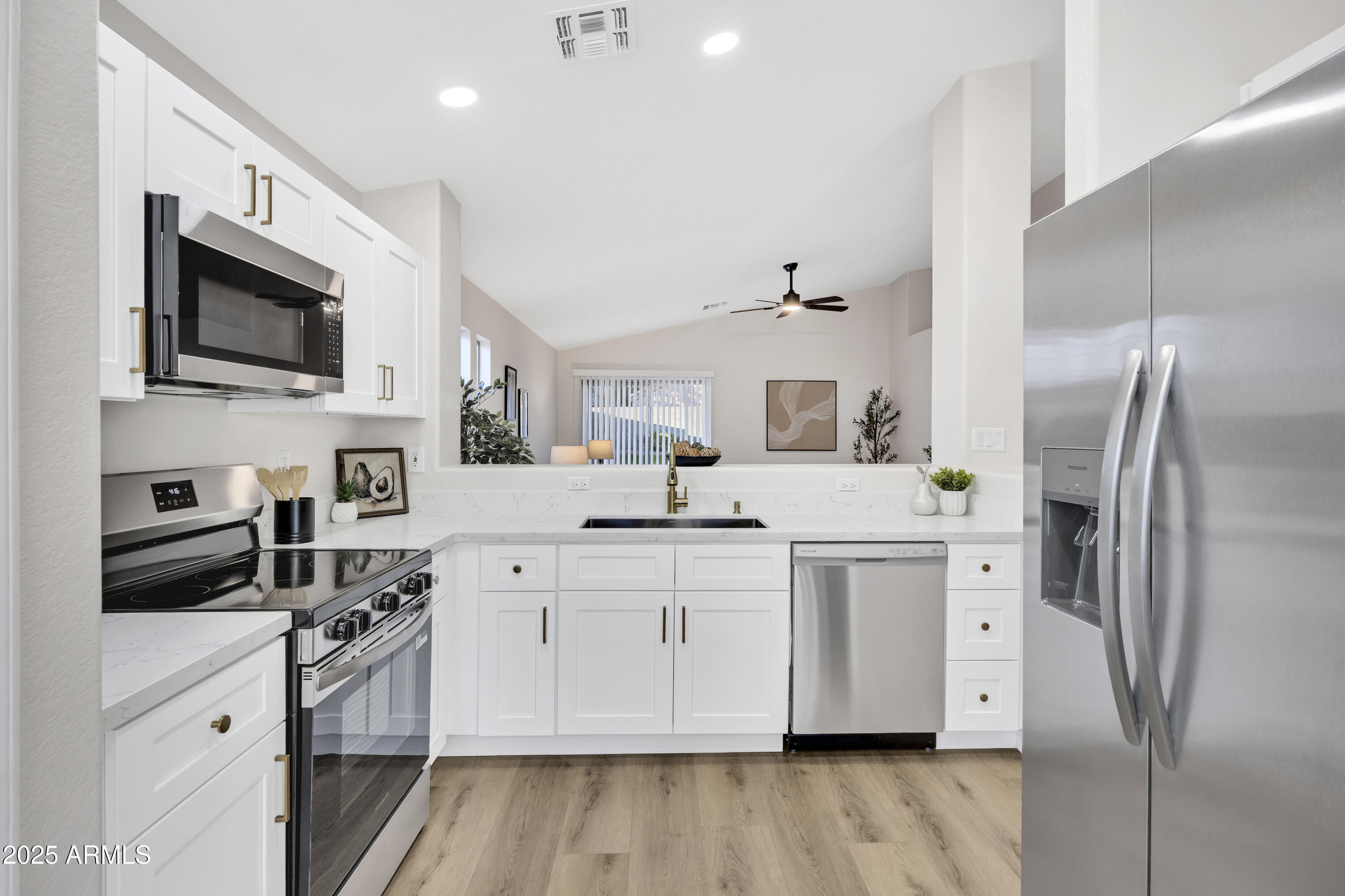 1228 West Diamond Avenue Apache Junction, AZ 85120 - Photo 10 of 25 a kitchen with white cabinets and stainless steel appliances