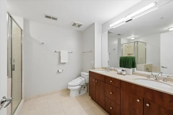 a spacious bathroom with a double vanity sink mirror and toilet