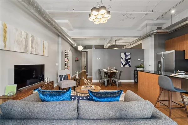 a living room with furniture chandelier and a fireplace