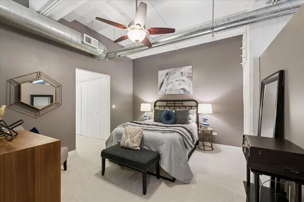 a bedroom with a bed and a mirror