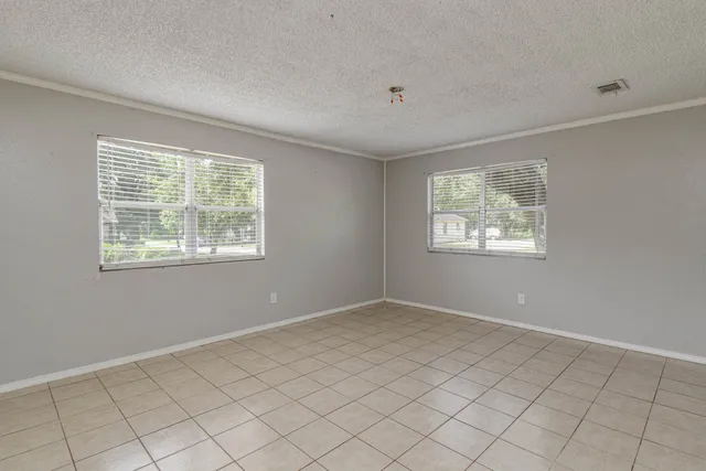 a view of an empty room with windows