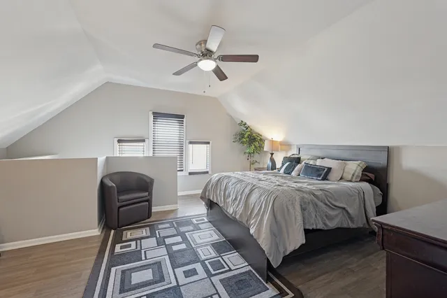 a bedroom with a bed and a chair