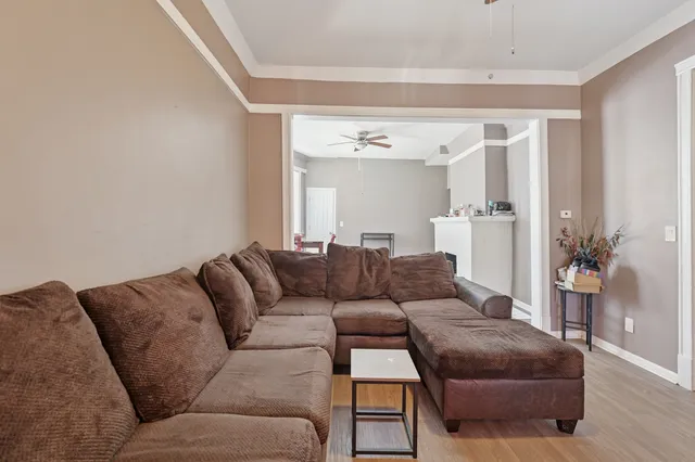 a living room with furniture and a mirror