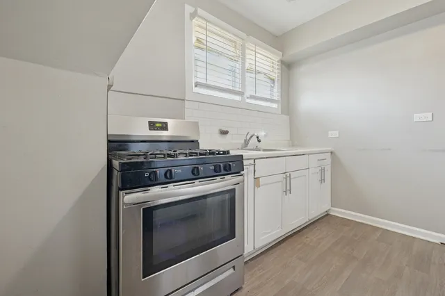 a kitchen with a stove oven and sink