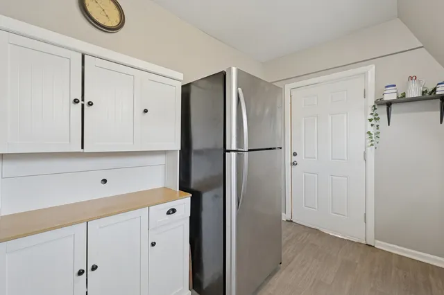 a kitchen with a refrigerator and cabinets