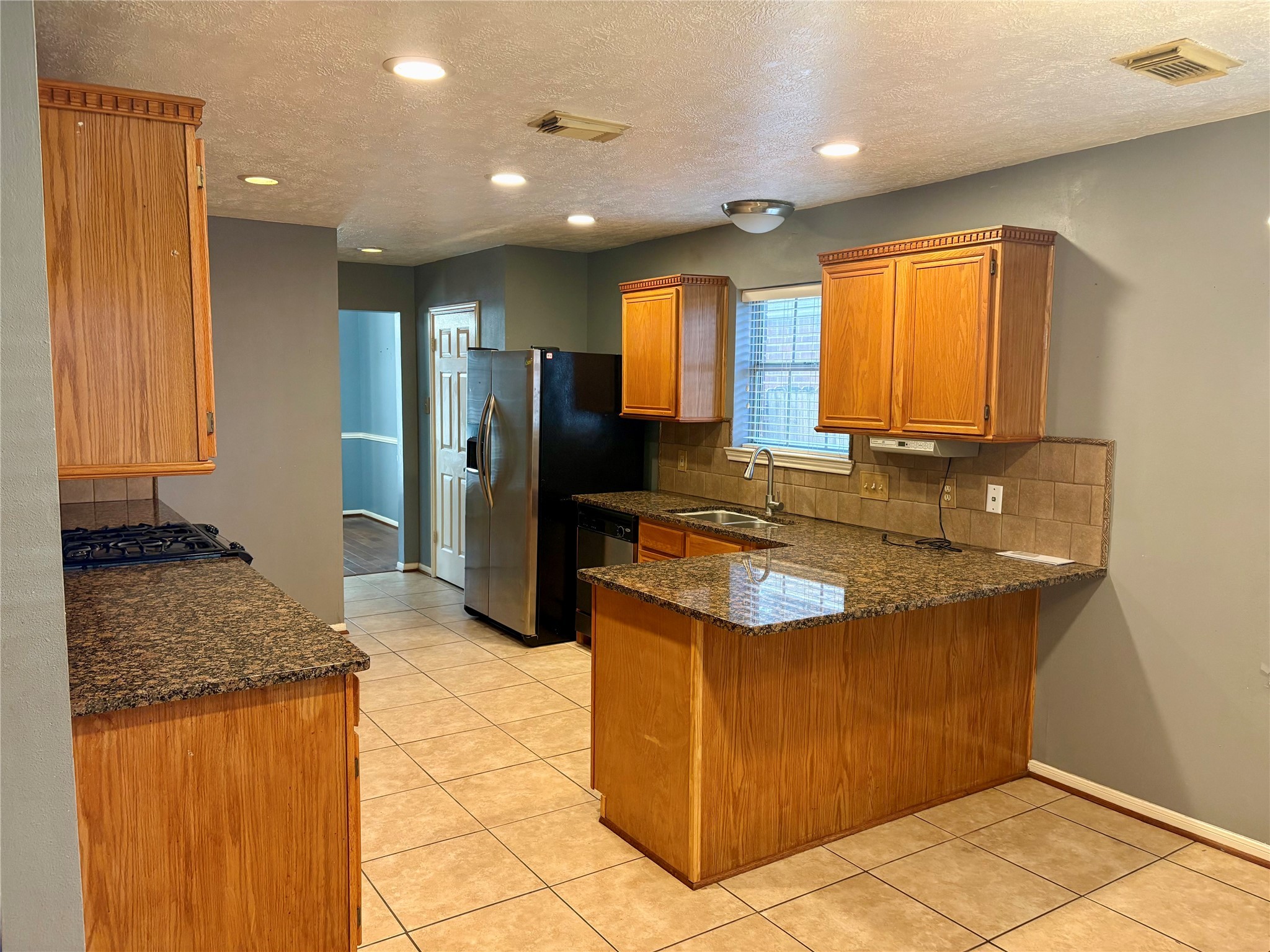 6510 Summit Ridge Court Houston, TX 77085 - Photo 2 of 10 a kitchen with stainless steel appliances granite countertop a sink stove and refrigerator