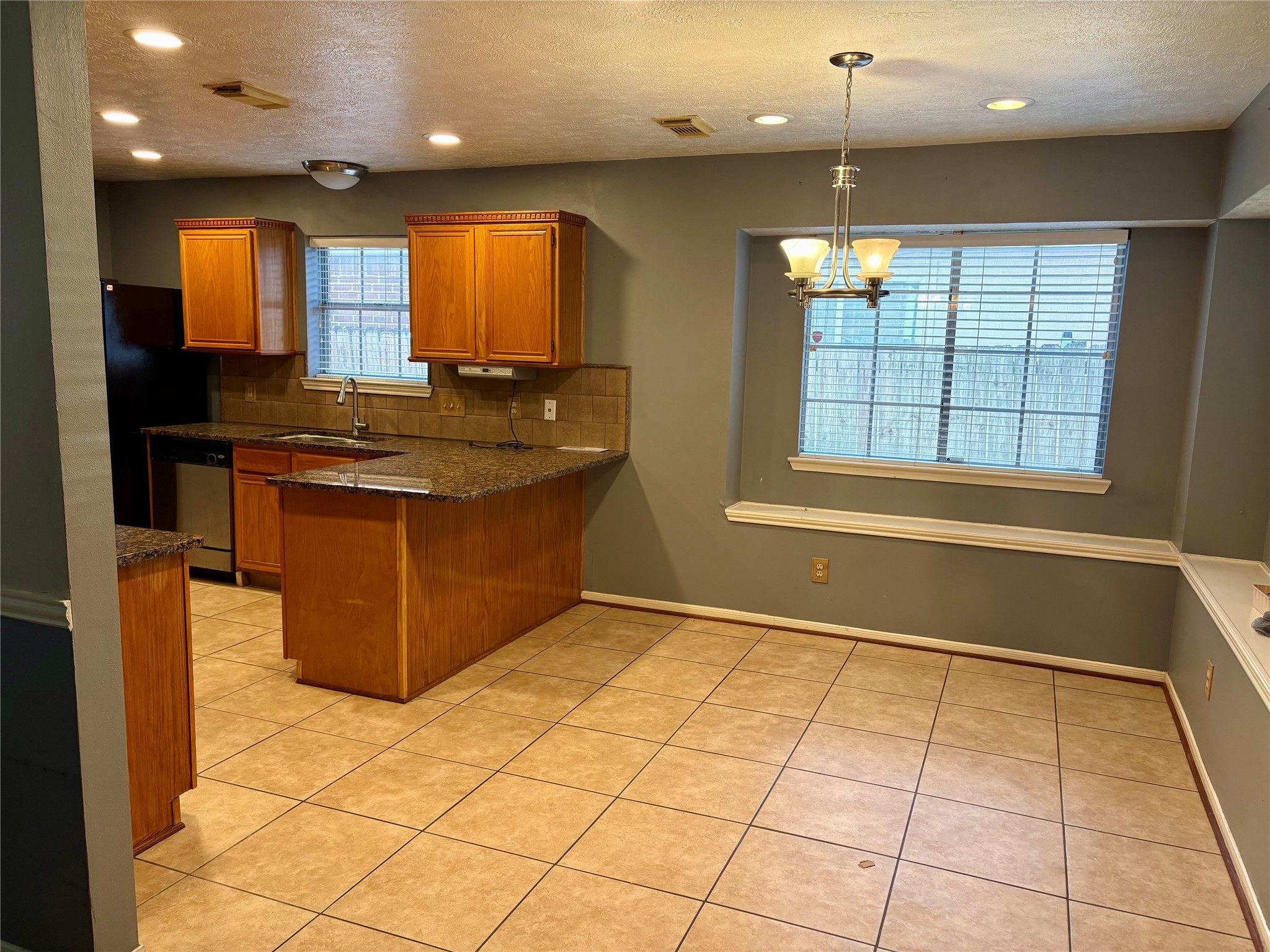 6510 Summit Ridge Court Houston, TX 77085 - Photo 3 of 10 a kitchen with stainless steel appliances granite countertop a stove a sink and a refrigerator