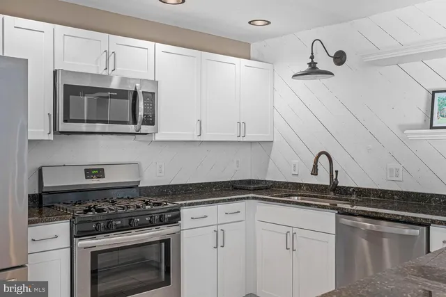 a kitchen with a sink cabinets and window